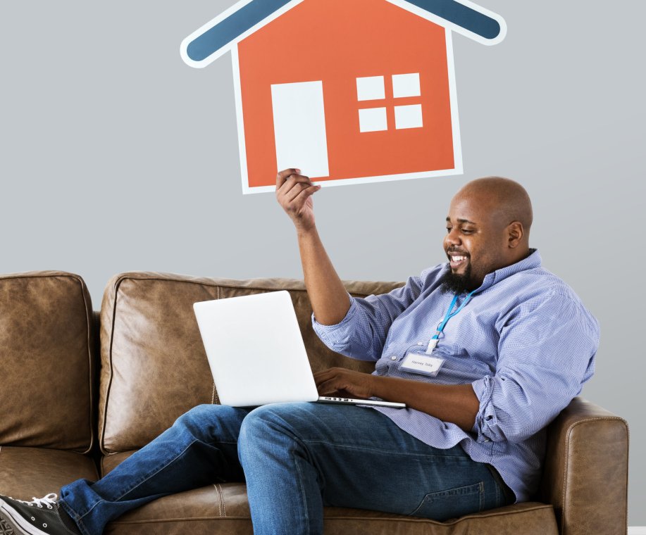 Man showing house icon on couch